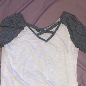 wire and grey shirt with x in back
